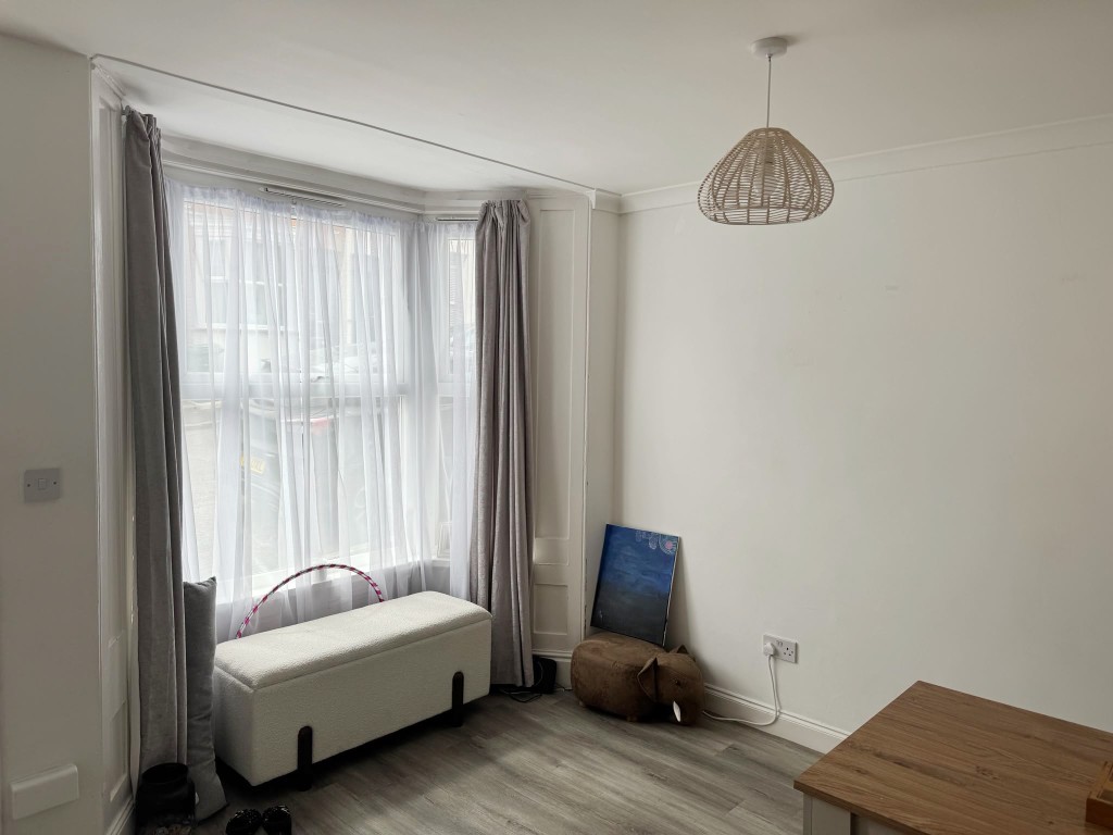 Lot: 149 - TWO-BEDROOM MID-TERRACE HOUSE FOR INVESTMENT - Front room with painted walls and wood effect flooring